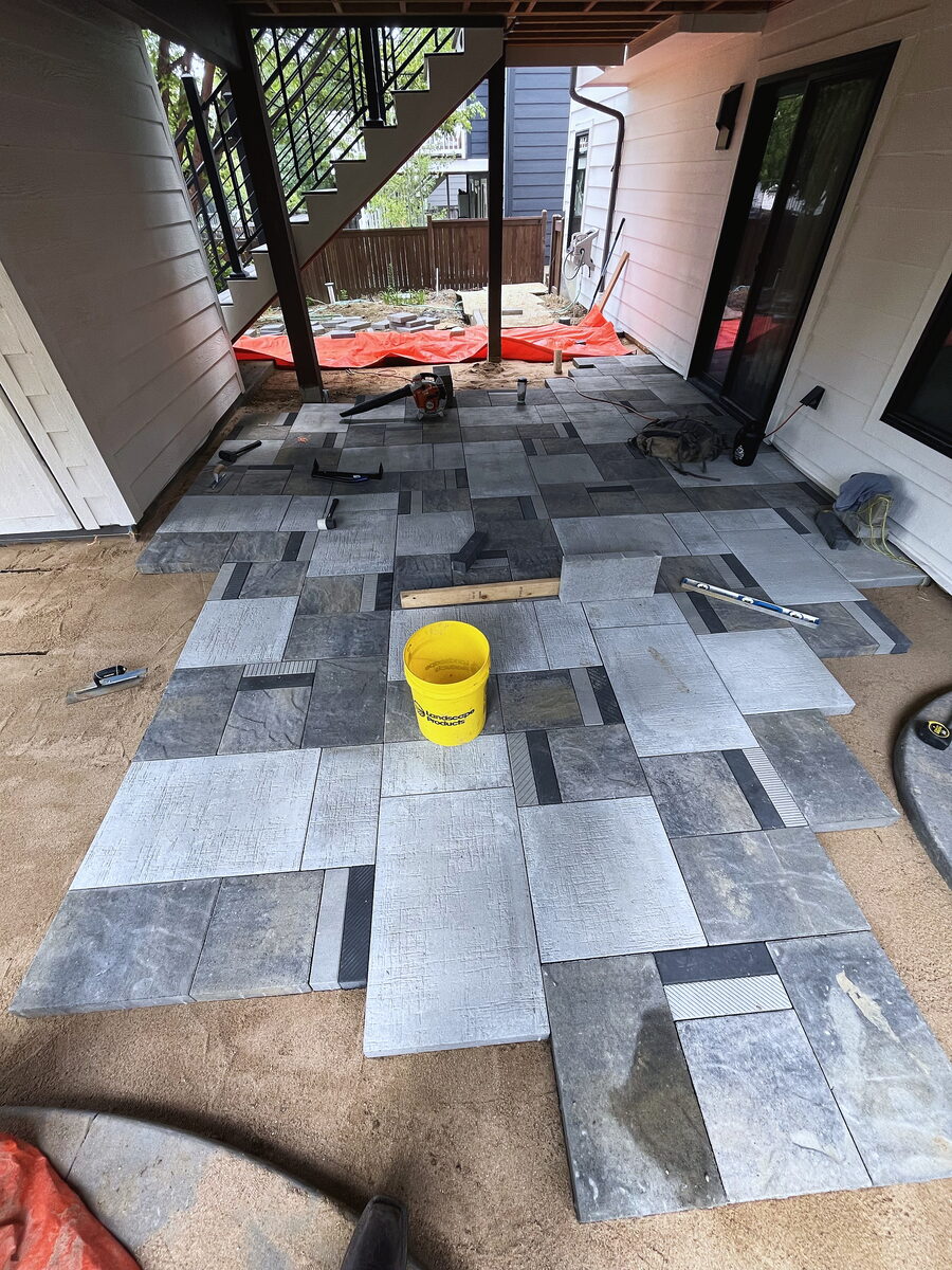 Large-format paver patio under installation by Brooks Landscape