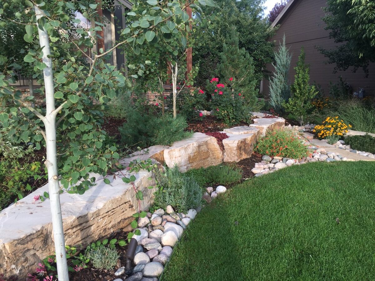 Stacked-stone retaining wall with flagstone steps by Brooks Landscape